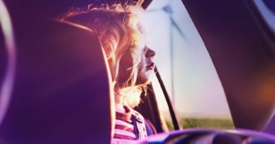 Girl in the car through lenses